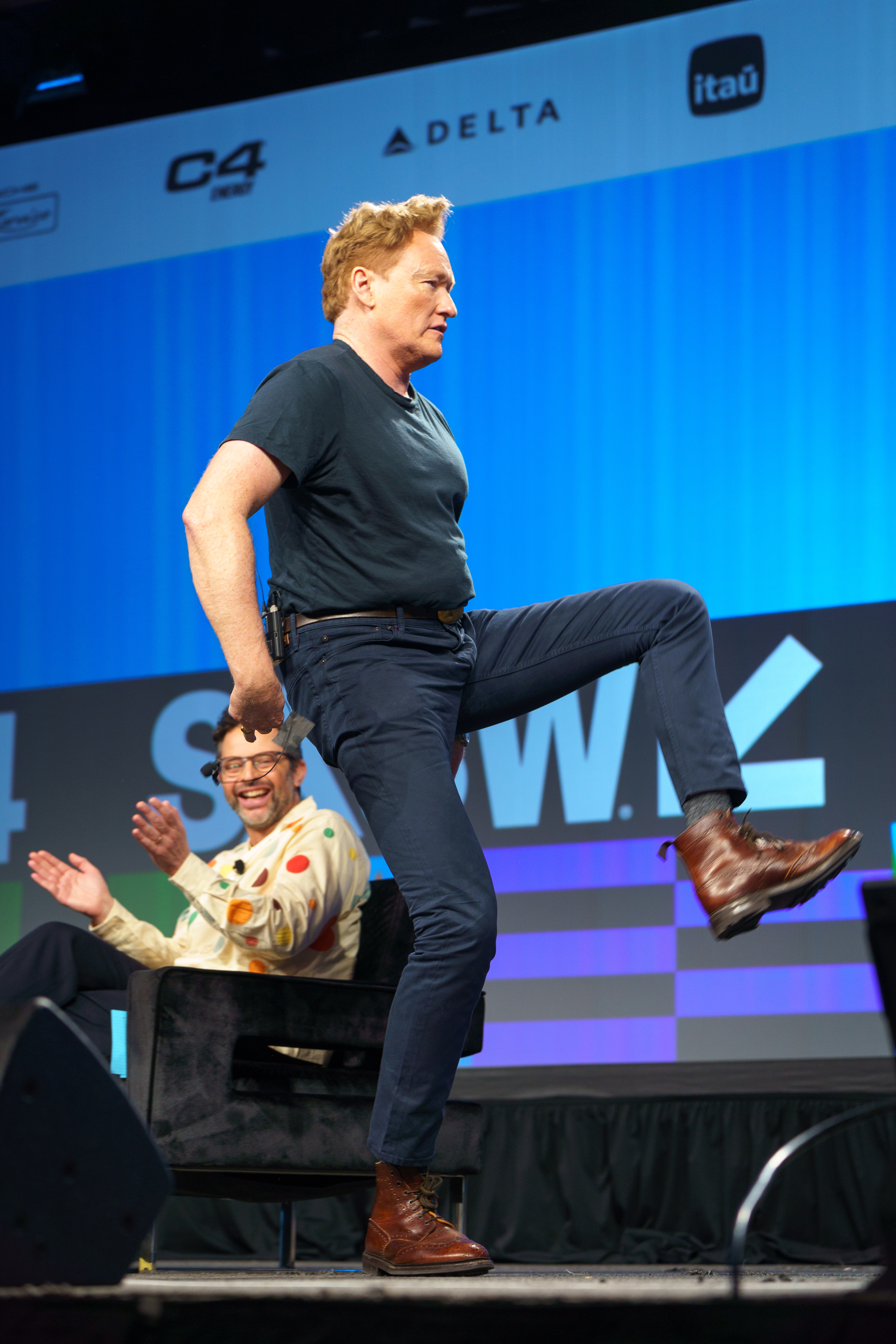 Conan O’Brien kicking onstage at SXSW 2024