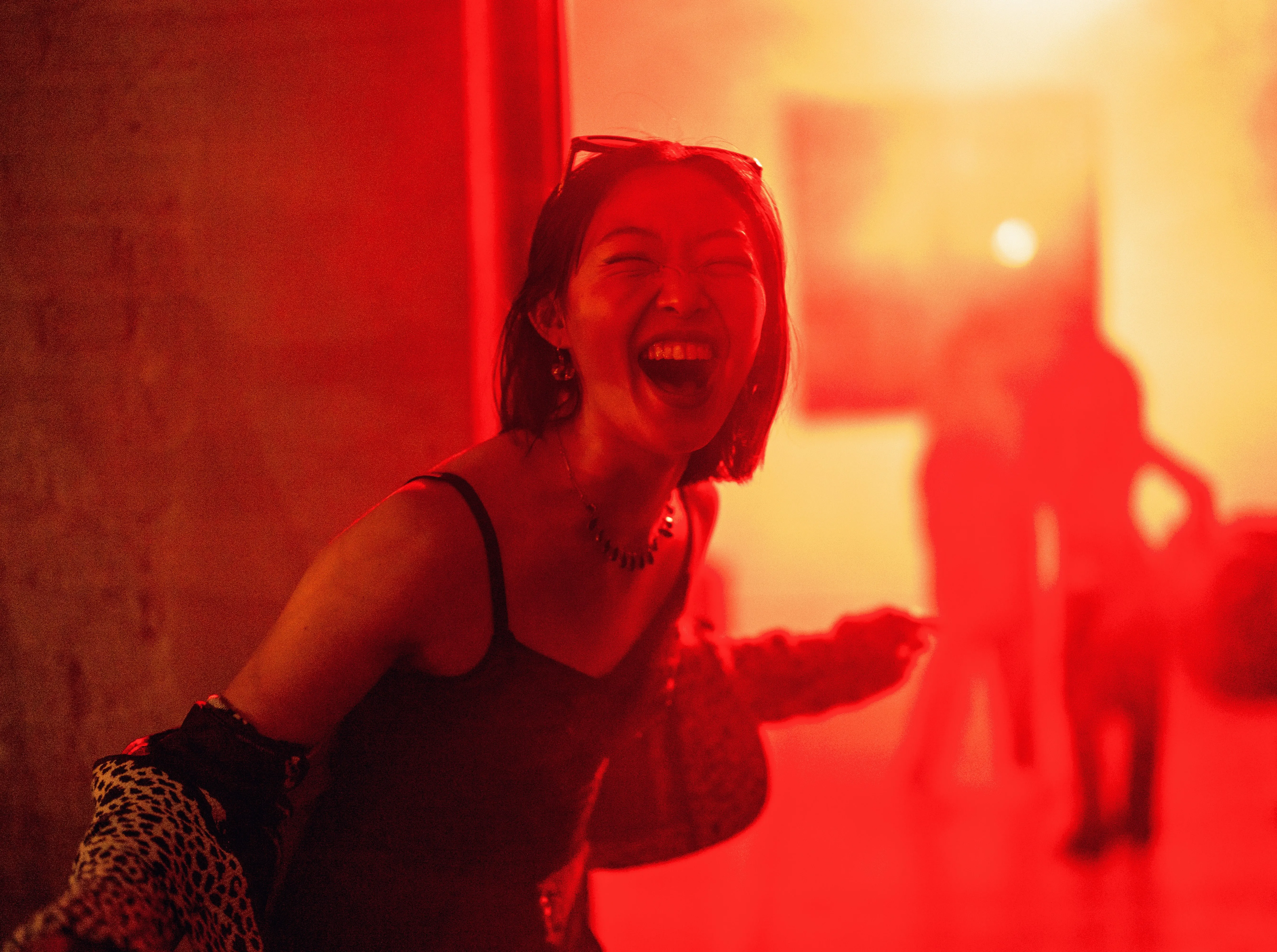 A woman smiling in red light