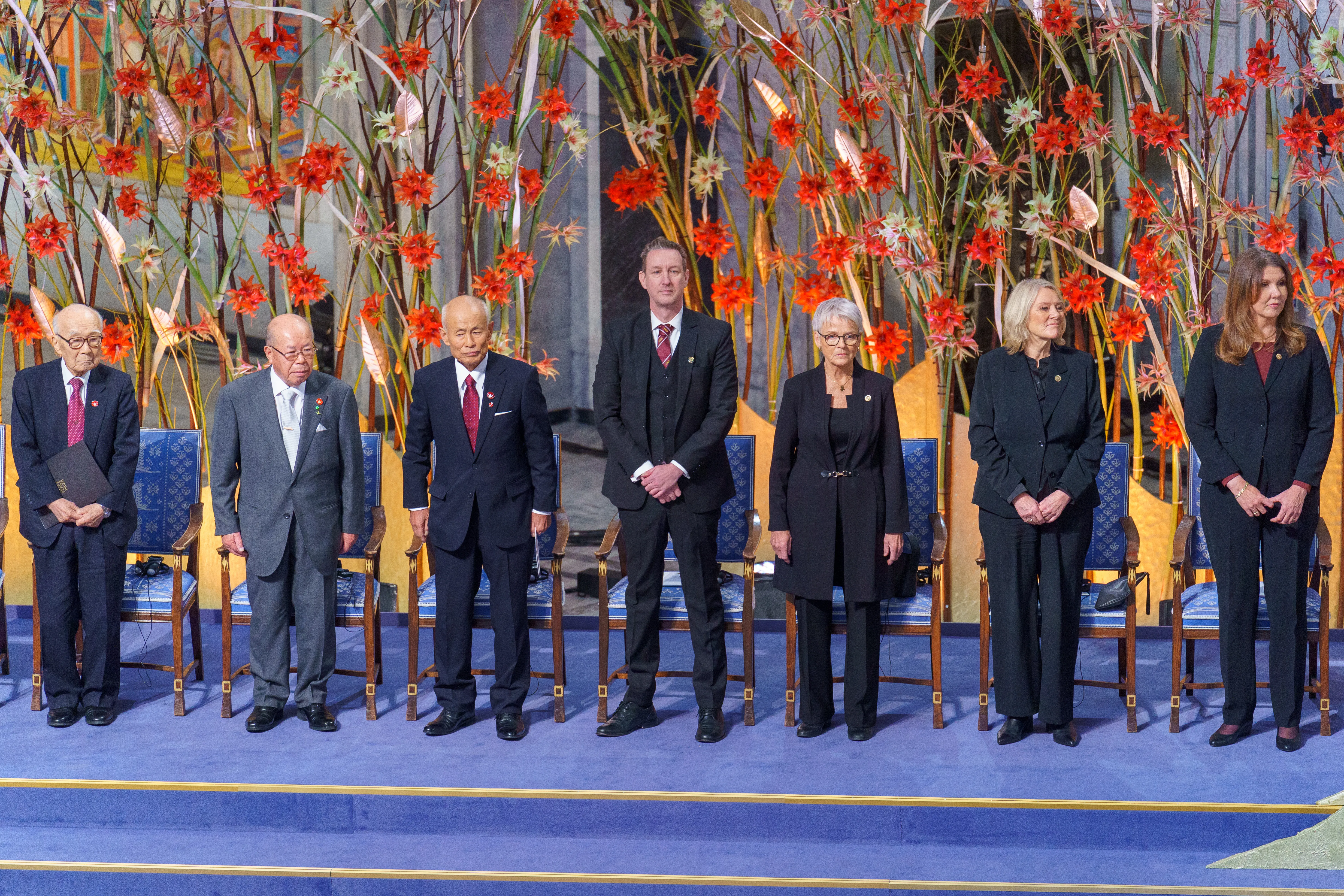 People standing onstage at the 2024 Nobel Peace Prize Ceremony in Oslo